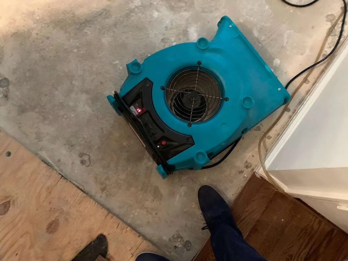 Air mover drying subfloor during Leak Detection & Repair in Obetz